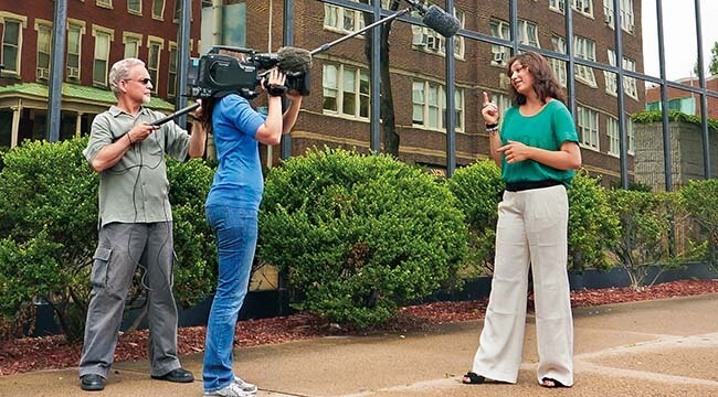 Woman talking in front of a video camera