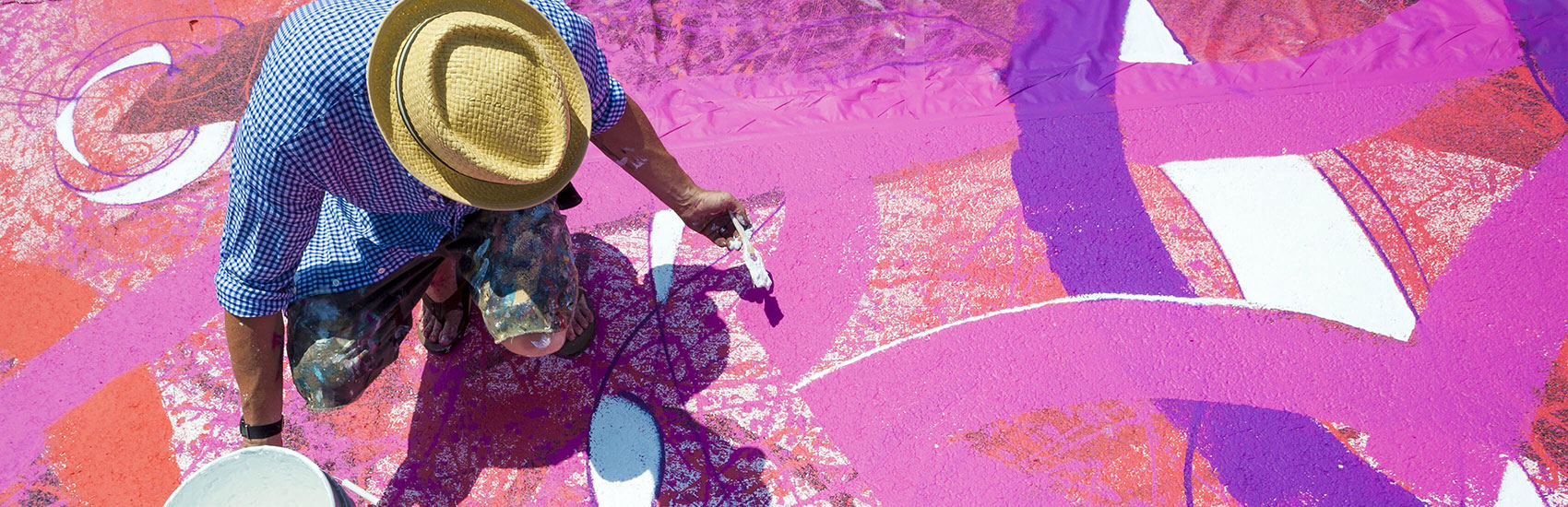 Richmond artist and School of the Arts alumnus Ed Trask works on a painted logo at a groundbreaking event for VCU’s Institute for Contemporary Art.