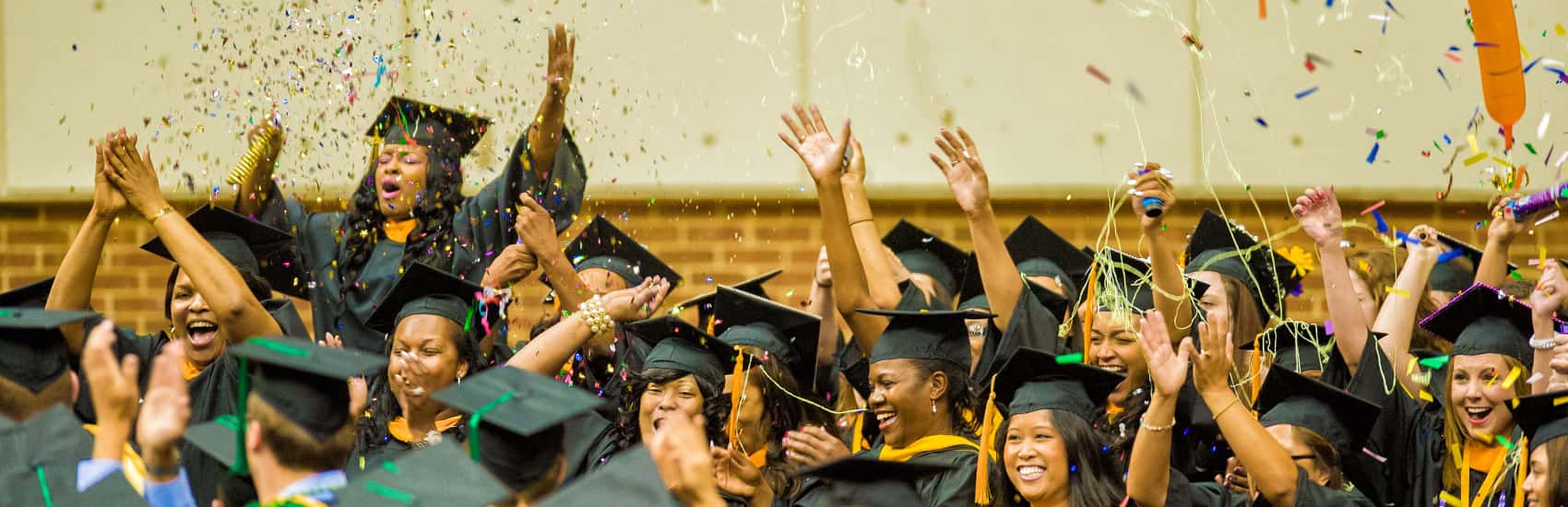 Graduates throwing confetti