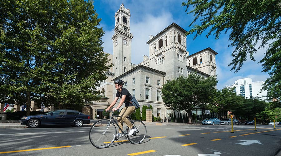 A cyclist rides past the Jefferson Hotel along East Franklin Street