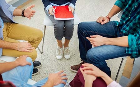 People sitting in a circle for group discussion