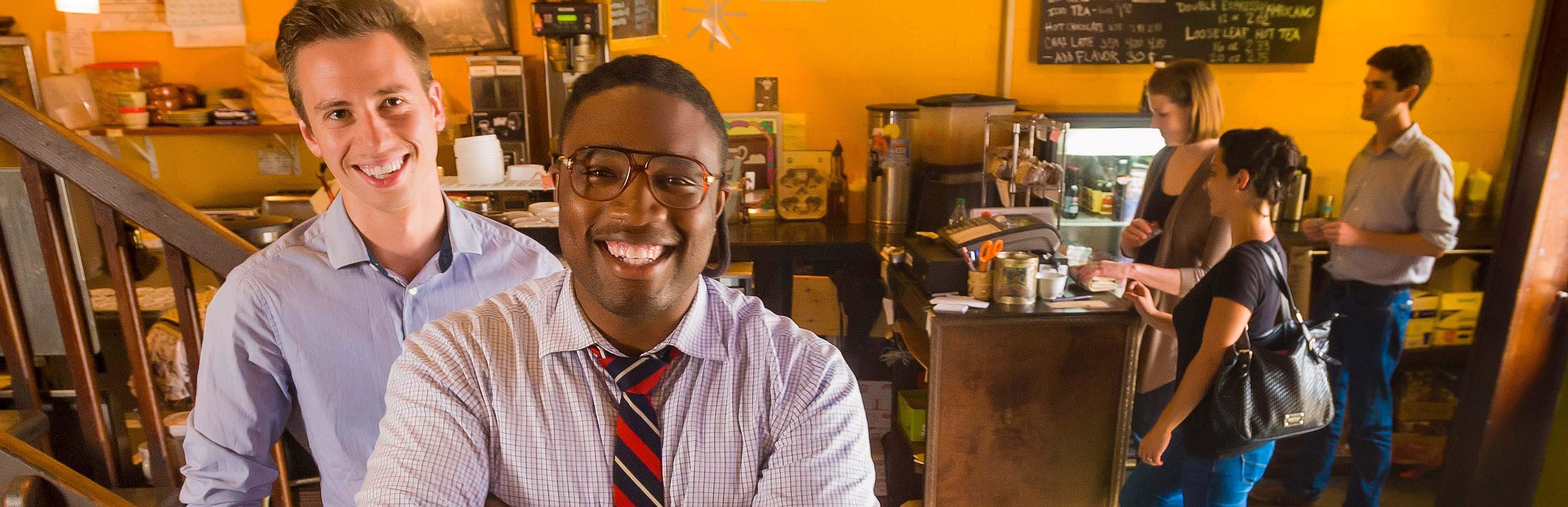 Two student entrepreneurs standing in a coffee shop